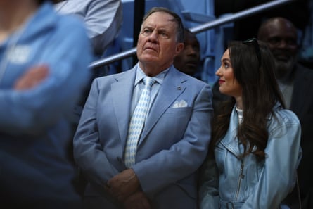 North Carolina football coach Bill Belichick and his girlfriend Jordon Hudson look on during the first half of the game between the Tar Heels and the Duke Blue Devils at the Dean Smith Center in March.