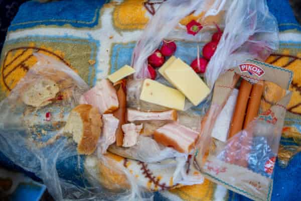 Plastic bags of bread, cheese, smoked meat, sausages and radishes