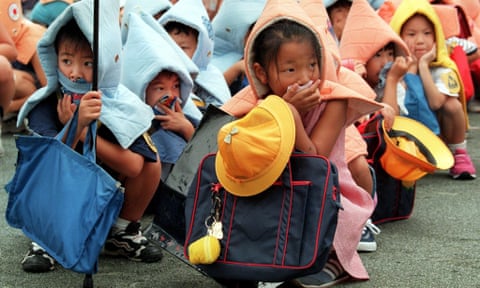 Children take part in a disaster drill at an elementary school in Tokyo 