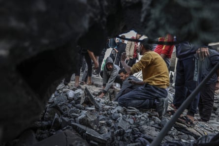 Rescuers at work amid rubble