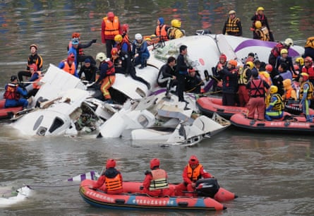 Rescue personnel search for passengers from the wreckage of a TransAsia ATR 72-600 turboprop plane that crash-landed into the Keelung river outside Taiwan’s capital Taipei.