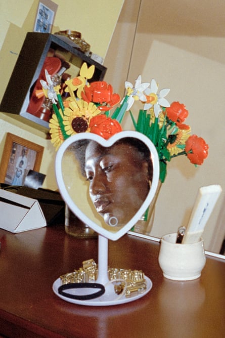 the reflection of a woman in a heart shaped mirror