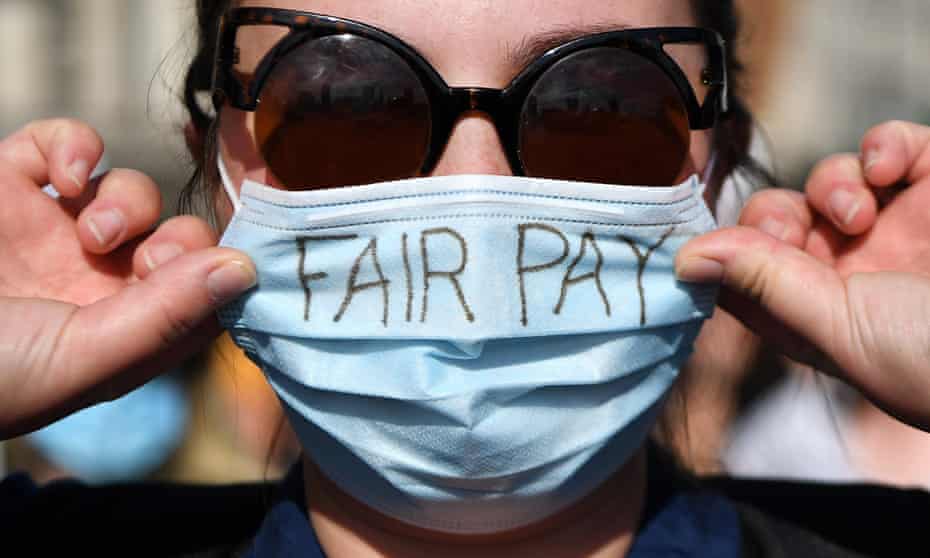 An NHS worker attends a protest march to Downing Street in 2020.