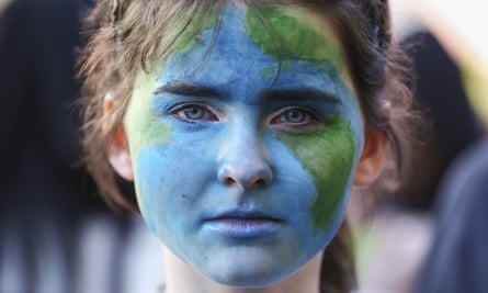A protester with the Earth painted on their face