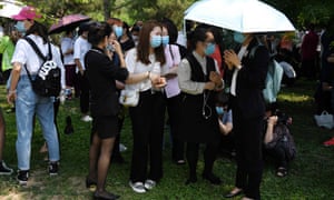 People wait in groups to undergo coronavirus tests in Beijing.