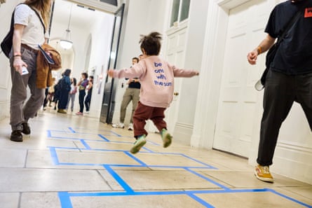 a young visitor plays Hopscotch.