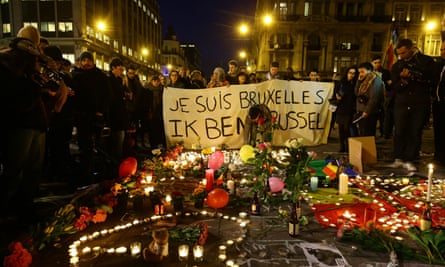 Members of the public gather at the Place de la Bourse in Brussels to leave messages and tributes.
