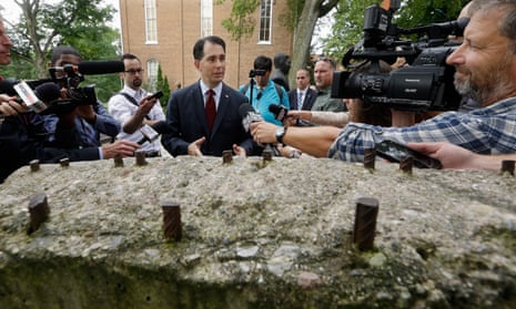Republican presidential candidate Scott Walker speaks to reporters in front of a piece of the Berlin Wall in the Ronald Reagan Peace Garden at Eureka College, Illinois, on Thursday.