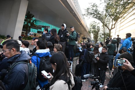 Members of the media wait outside the West Kowloon Magistrates’ court in Hong Kong on February 9, 2026, for the sentencing of convicted pro-democracy media tycoon Jimmy Lai.