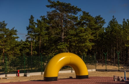 A construction site of the Kolnik–Gdańsk gas pipeline with fencing and trees behind it