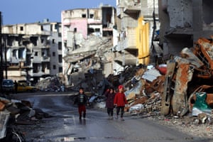 Children walk along a destroyed street in Raqqa, the former de facto capital of the Islamic State group.