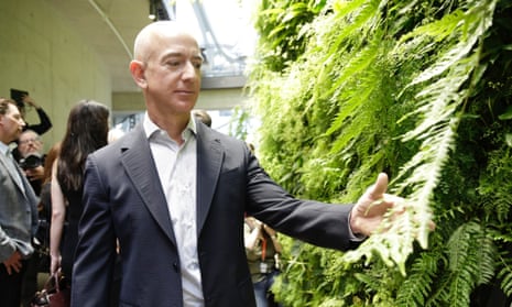 Amazon’s CEO, Jeff Bezos, tours a facility in Seattle. Various cities have offered the company billions in tax incentives.
