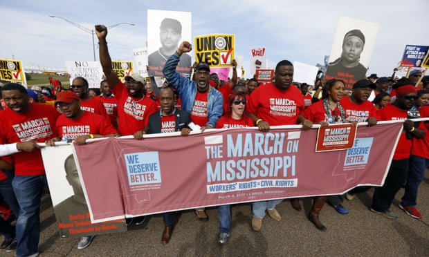 Auto workers and others march to Nissan’s Canton, Mississippi, plant following a pro-union rally in March.