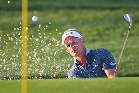 Luke Donald plays a shot from a bunker