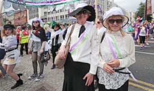 Women dressed as suffragettes take part in the Processions’ artwork march, in Belfast