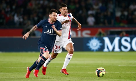Lionel Messi is challenged for the ball by Bruno Guimarães during PSG’s narrow win over Lyon.