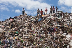 Rubbish pickers stand on a rubbish dump on the outskirts of San Pedro Sula