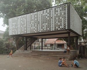 children sit outside building