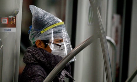 A subway passenger wears a face mask among other protective items in Shanghai