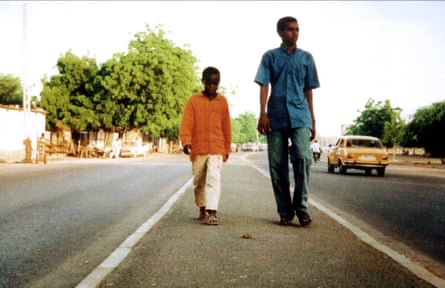 Two boys walk towards camera