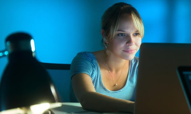 A woman working in an office late at night