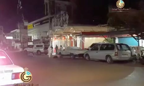 Emergency officials stand outside a bar after gunmen shot dead a journalist early on Sunday in the Mexican city of Iguala in the south-western state of Guerrero on Sunday.