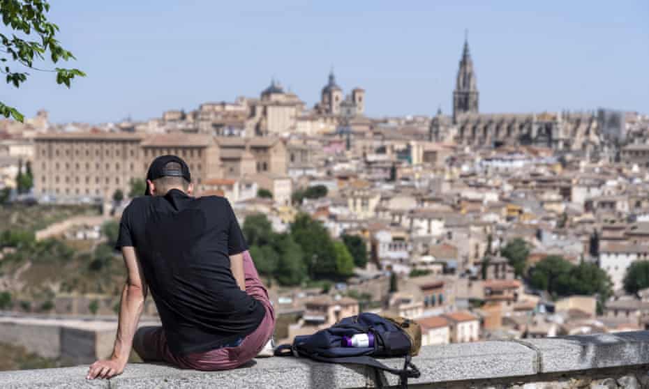  A man rests under the sun with the old quarter of the city of Toledo in the background, central Spain, 19 May 2022. The temperature is to reach up to 37 Celsius degrees in the city during the day.