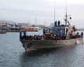 A Libyan coastguard ship arriving at a naval base in Tripoli carrying rescued people.