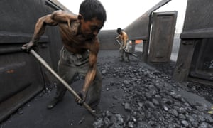 Workers unloading coal at a storage site along a railway station in Hefei, China. <br>