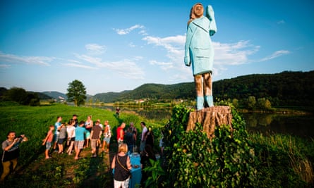 People gather around a statue of Melania Trump on the outskirts of Sevnica, on 5 July.