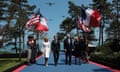 President Joe Biden and first lady Jill Biden walk with President Emmanuel Macron and his wife Brigitte Macron arriving at a ceremony in Colleville-sur-Mer.