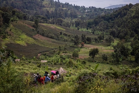 Biologist Cédric Muliri and friends talk to members of the Batwa community near the edge of Kahuzi-Biega national park