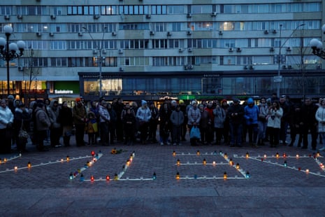 A commemorative rally for people killed a year ago inside the building of Mariupol's Drama Theatre in front of the Opera Theatre in Kyiv, Ukraine. The inscription reads, "Children".