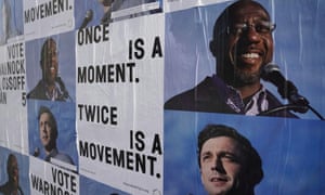 Campaign ads for Jon Ossoff and Raphael Warnock are seen on a wall near the John Lewis mural the day after the US Senate runoff elections in Atlanta, Georgia.