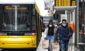 Two people seen outside a bus stop in Berlin, Germany as the country mulls whether to impose another lockdown.