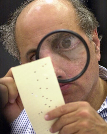 In 2000, a Broward county canvassing board member, Judge Robert Rosenberg, examines a ballot.