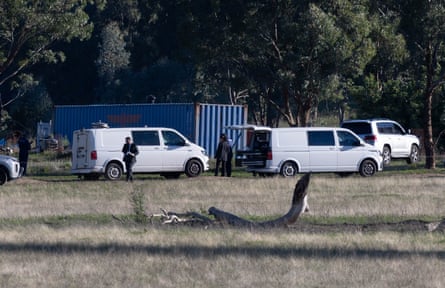 Police and forensic investigators at the shipping containers where Dezi Freeman was located.
