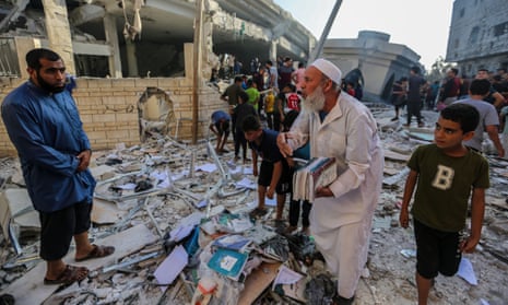 Citizens inspect the Khaled bin al-Walid mosque, which was destroyed by Israeli raids on 8 November 2023 in Khan Yunis, Gaza.