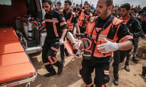 A wounded Palestinian is evacuated during the clashes between demonstrators and Israeli troops. 