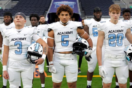 NFL Academy players l-r Michael Szabo, quarterback from Vienna Austria, Joel Queisser linebacker from Dusseldorf Germany and Moritz Strempel linebacker from Cologne Germany, line up for the US and UK national anthems before the match NFL Academy against De La Salle Spartans.