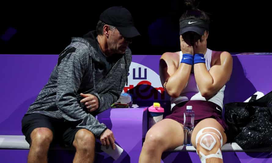 Bianca Andreescu speaks to her coach, Sylvain Bruneau, after sustaining an injury to her left leg at Shenzhen in October 2019