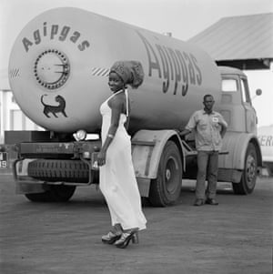 A woman poses in front of a tanker