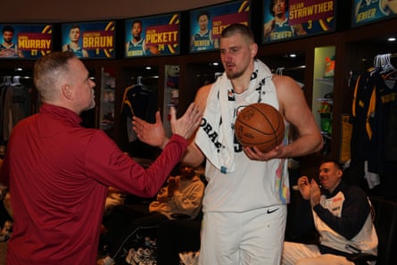 Nikola Jokić s is awarded the game ball after recording the first 30-20-20 game in NBA history on Friday night.