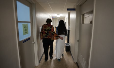 A 33-year-old mother of three from central Texas is escorted down the hall by clinic administrator Kathaleen Pittman prior to getting an abortion, Saturday in Shreveport, Louisiana.