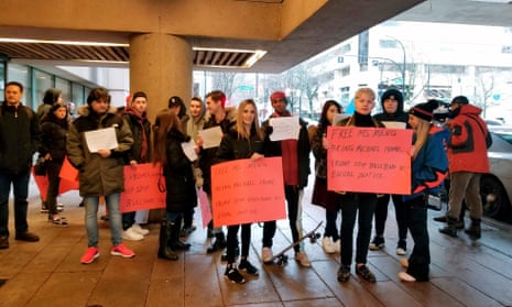 Protesters stand outside a Vancouver courtroom on 20 January 2020.