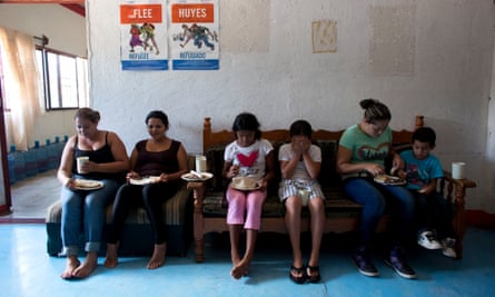 Carmen Gomez, Cynthia Lemus<br>In this Wednesday, June 18, 2014 photo, women and children, including Carmen Gomez, second left, and daughter Cynthia Lemus, third left, watch tv as they eat lunch in the women’s section of a shelter providing temporary refuge for Central American migrants traveling north, in Arriaga, Chiapas State, Mexico. Shelters such as the one in Arriaga offer migrants unable to afford a hotel a safe place to rest for a few days and access to regular meals. (AP Photo/Rebecca Blackwell)