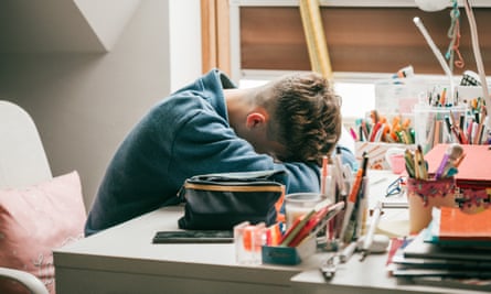 Boy laying his head on a desk