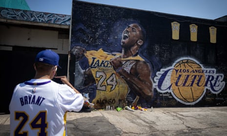 A man wearing a Kobe Bryant jersey visits a mural on what is being called Kobe Bryant day in Los Angeles on 24 August.