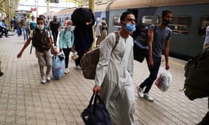 People wearing face masks are seen at Ramses railway station in Cairo.