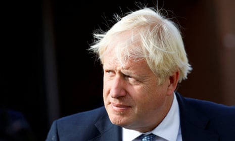 Boris Johnson in a blue suit with signature windswept hairstyle